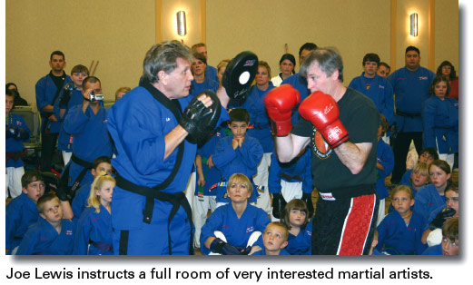 Joe Lewis instructs a full room of very interested martial artists.
