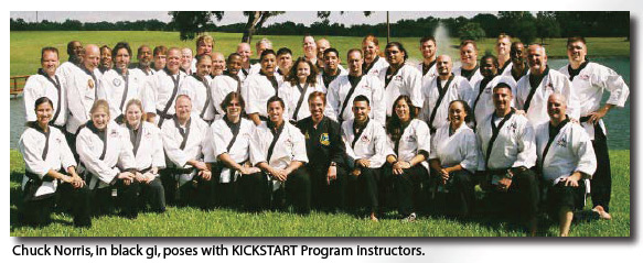 Chuck Norris, in black gi, poses with KICKSTART Program instructors.