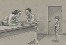 Two instructors talking at the school's front counter while a young student waits nearby