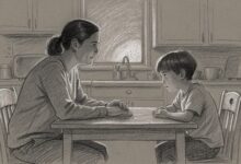 A parent and child talking across the kitchen table