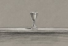 A single trophy alone on an otherwise empty shelf