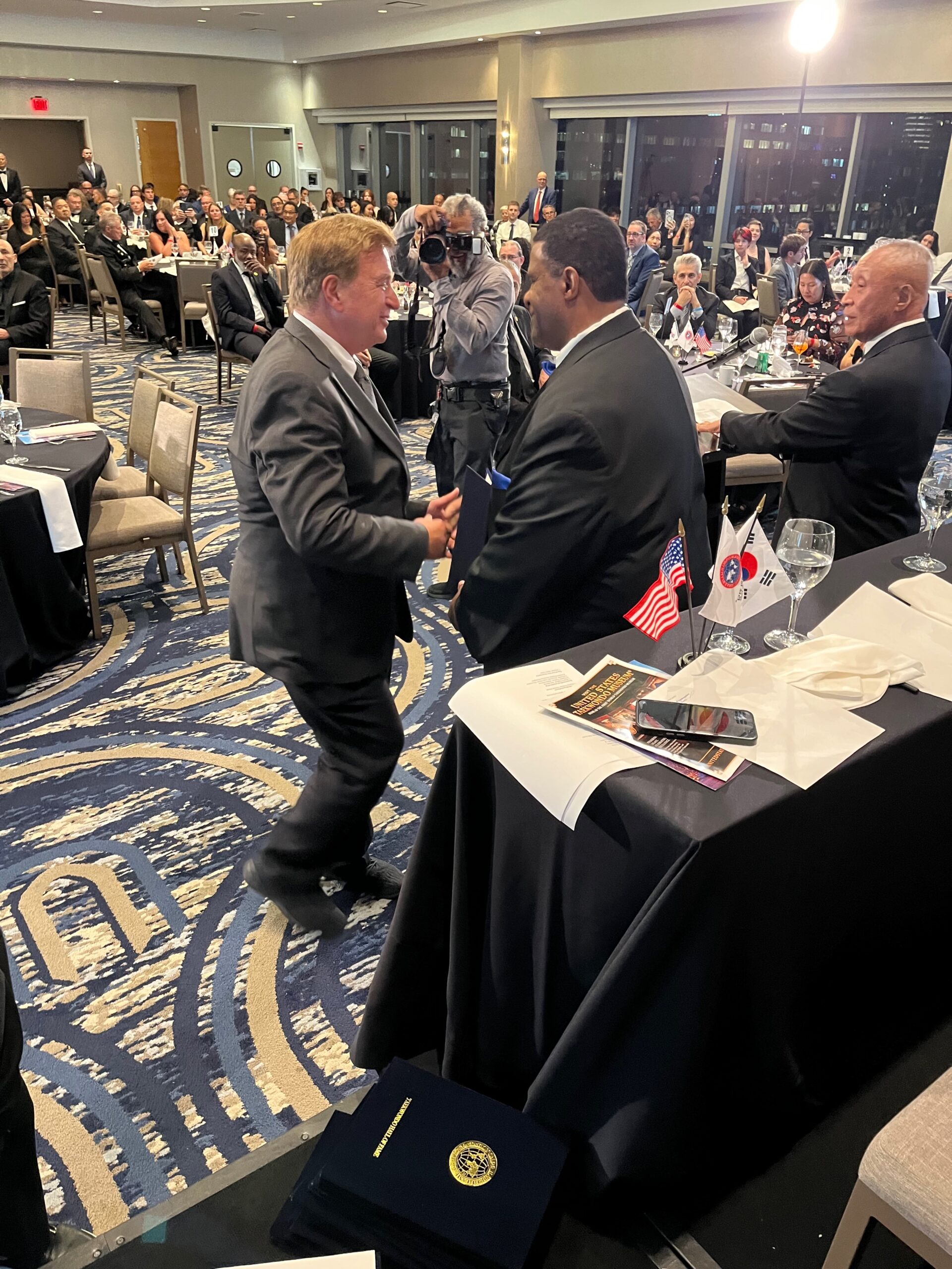 Guests in formal dress seated at round tables during the 2026 Official Taekwondo Hall of Fame ceremony