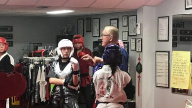 Grand Master Jeff Smith coaching students through sparring drills in headgear