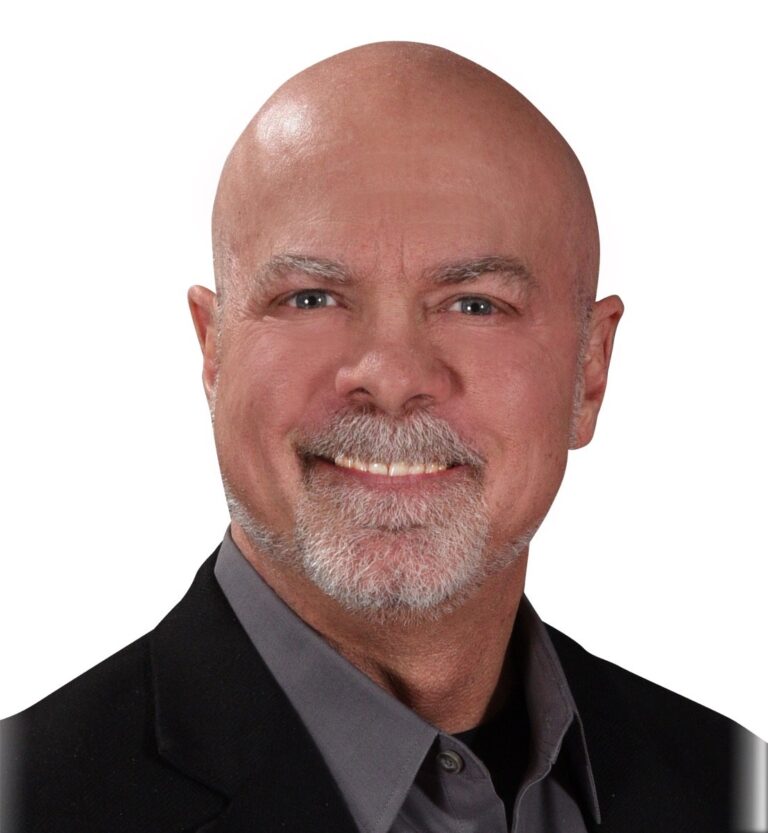 Dr. Greg Moody in a dark jacket, smiling