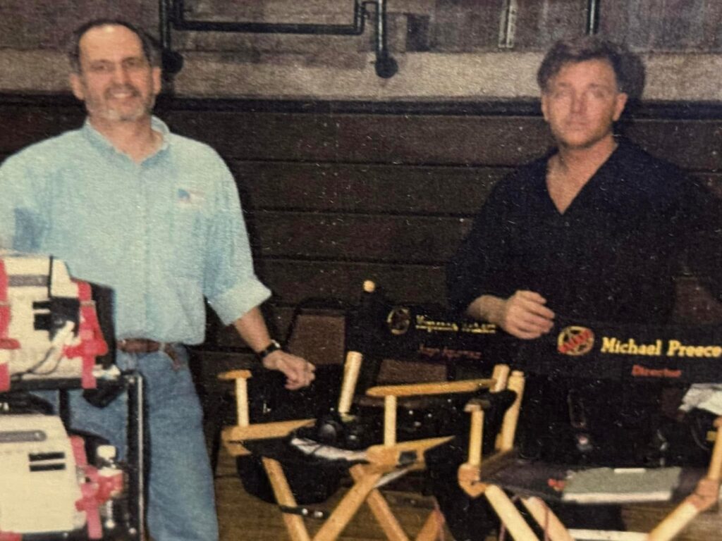 Stephen Oliver and Ed Saenz on the Walker, Texas Ranger set beside production chairs, one marked Michael Preece, Director